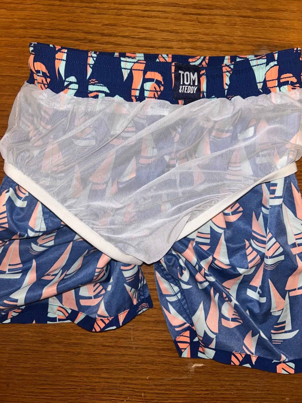 Boys Tom & Teddy Navy Swim Trunks with Coral and Light Blue Sailboat Motif